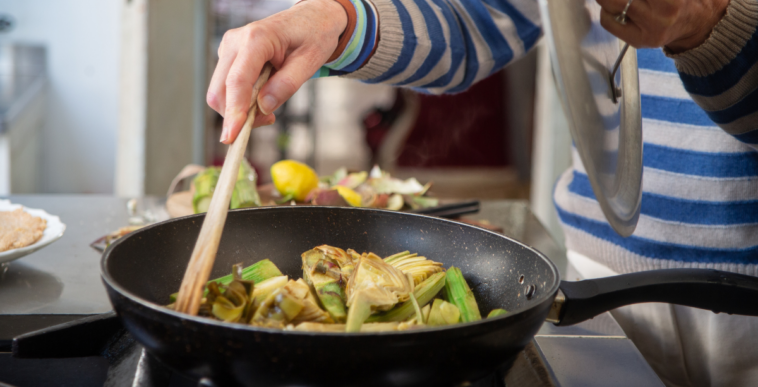 close-up of an older woman cooking