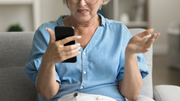 Angry woman looking at her phone