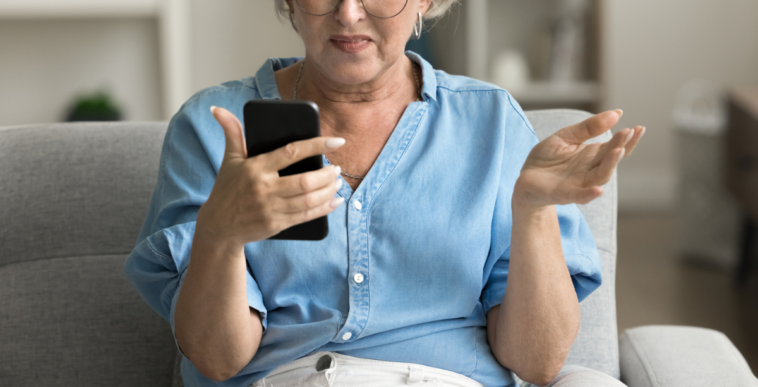 Angry woman looking at her phone