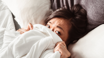 Woman tucked into bed