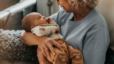 older woman holding infant