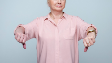 older woman giving two thumbs down