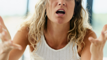 upset woman pleading with unseen person