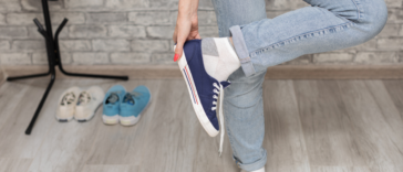 Someone taking off their sneakers.