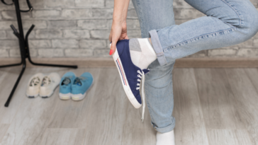 Someone taking off their sneakers.