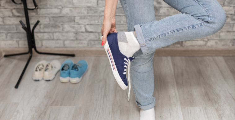 Someone taking off their sneakers.