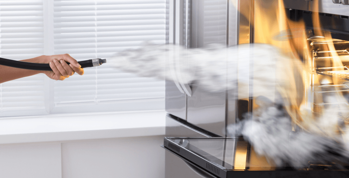 Person putting out fire in a stove