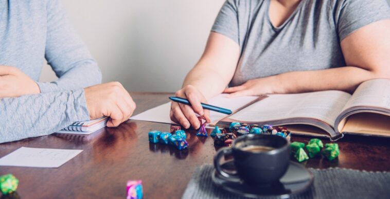 man and woman playing table top role-playing dice game