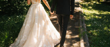 A bride and groom walking hand in hand.