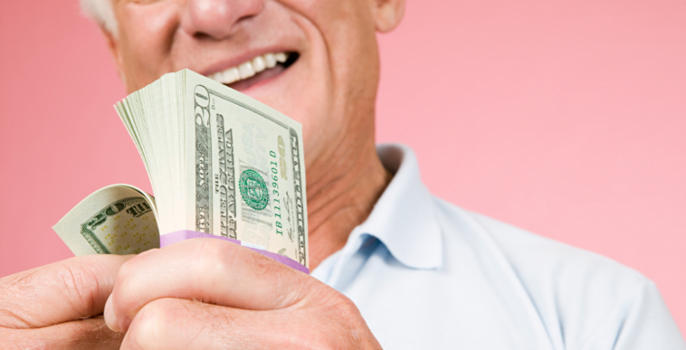 A man holding a wad of cash.