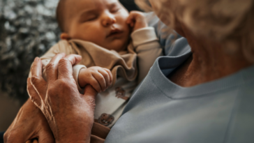 Grandparent holding their grandchild