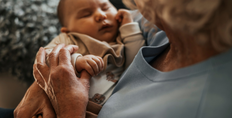 Grandparent holding their grandchild
