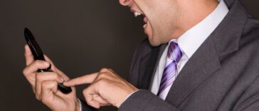 Man yelling at his mobile phone.