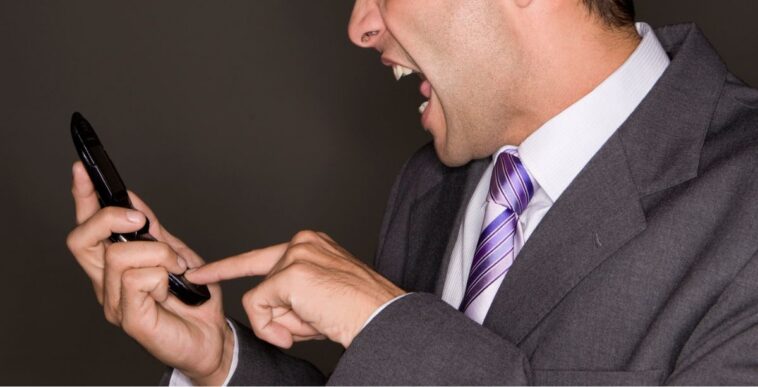 Man yelling at his mobile phone.
