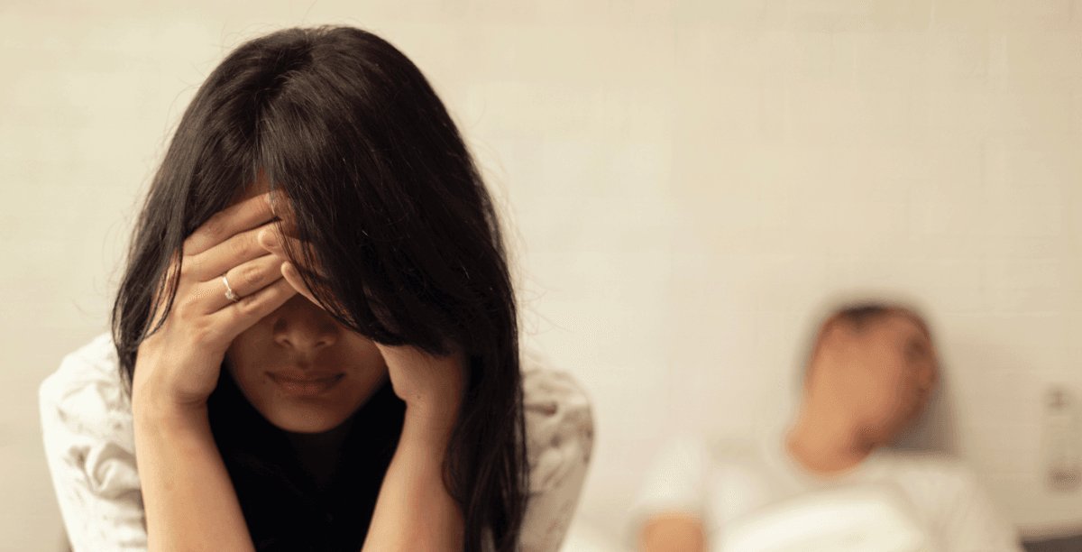 Couple arguing in bed