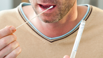 man getting DNA swab for genetic testing