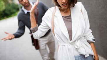 woman walking away from man on street