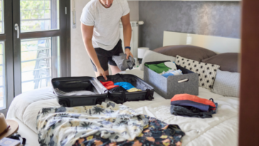 man packing for vacation