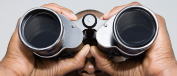 Man looking through binoculars