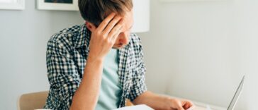Pensive man thinking about high prices. Managing family finances. Rise of utilities, gas, electricity, rental charges, water bill due to inflation and global crisis. Facing downturn including energy. Planning family budget while sitting in kitchen.