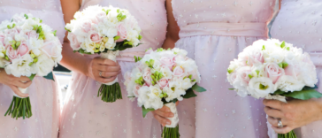 A line of bridesmaids holding bouquets.
