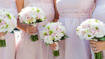 A line of bridesmaids holding bouquets.