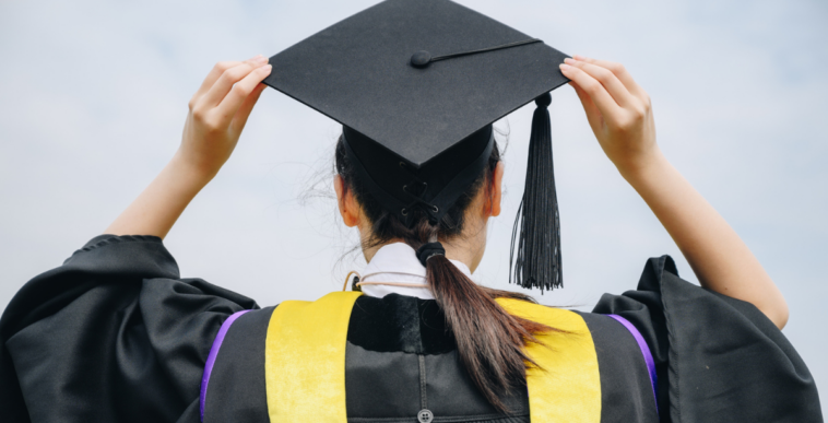 A woman in a graduation cap and gown.