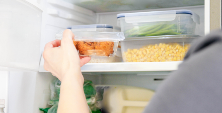 Person taking leftovers out of the fridge