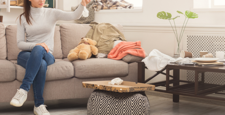 woman sitting in a messy living room