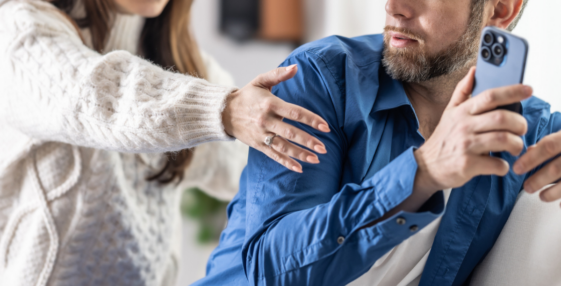 Man hiding his phone from his wife