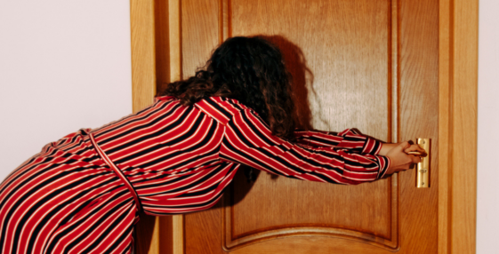Woman pulling on door handle