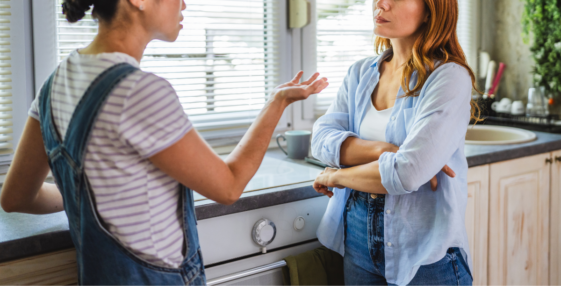 two women have disagreement in kitchen