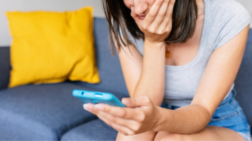 upset woman looking at phone