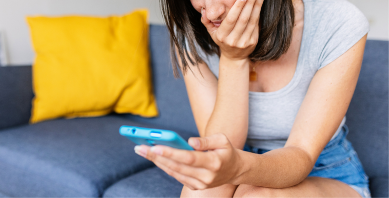 upset woman looking at phone