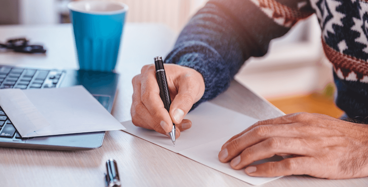 man writing thank you note
