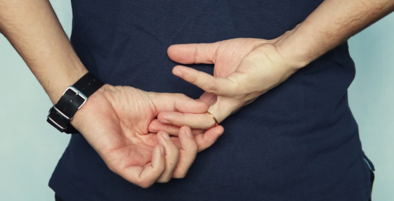 man removing wedding ring behind his back